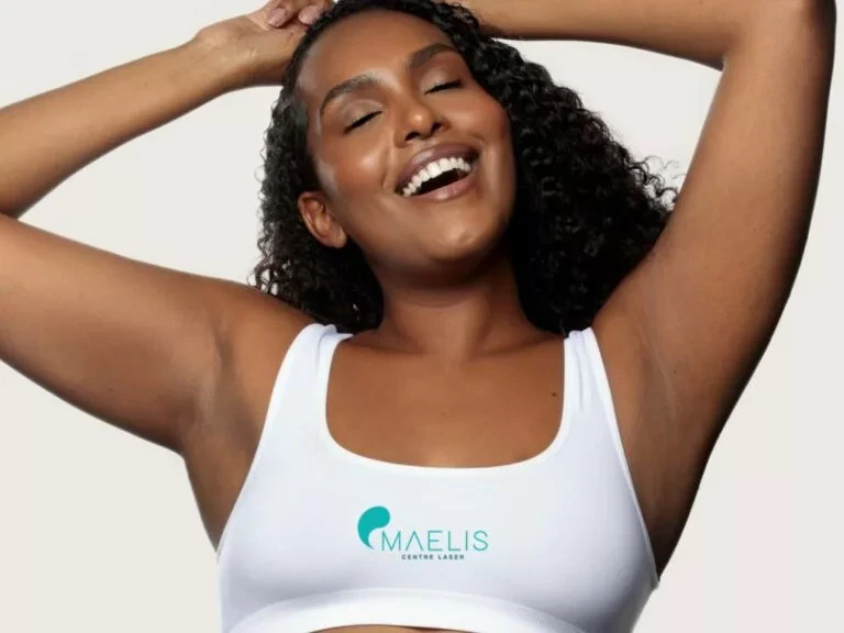Femme à la peau foncée ou noire ayant les bras levée laissons apparaître ses aisselles parfaitement épilée au laser définitif chez Maelis